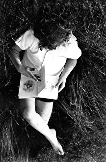 Krish: Boy about 9 lies in the grass reading