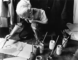 Roughly: Boy in an art class at a Kilburn school