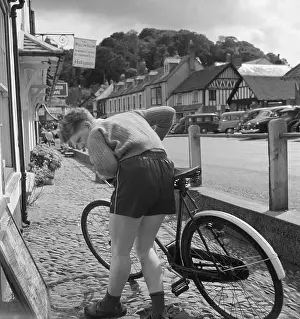 Stooping: Boy with bicycle