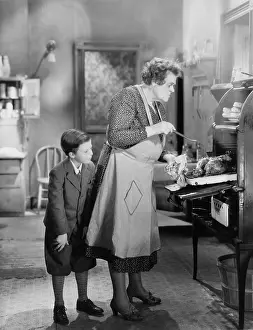 Grandparent: Boy with cook in kitchen cooking dinner