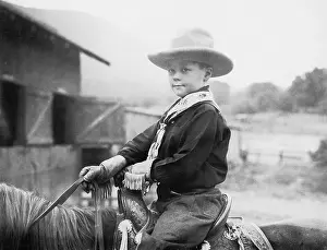 Corral: Boy in a cowboy hat on a horse
