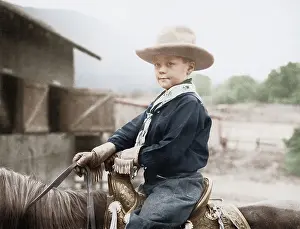 Corral: Boy in a cowboy hat on a horse