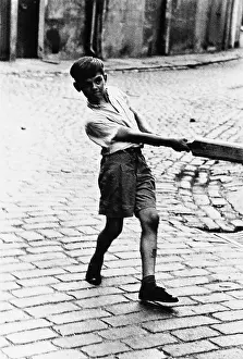 Addison: Boy with cricket bat in Addison Place