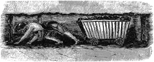 Dragging: Boy dragging coal wagon with harness and chain in mine