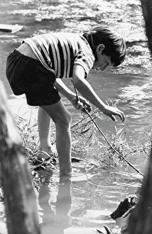Intensely: Boy exploring in shallow water