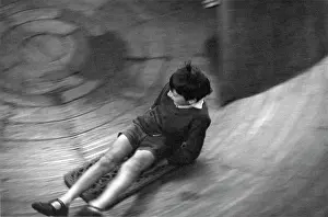 Skelter: Boy on final section of a helter skelter at the fair