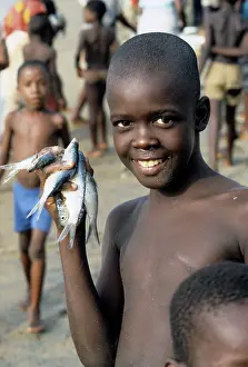 Freetown: Boy with fishes, Sierra Leone