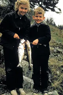 Rewarding: Boy and Girl Holding up Two Fish Catch of the