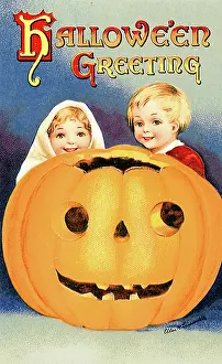 Pumpkin: Boy and Girl behind large Jack O Lantern