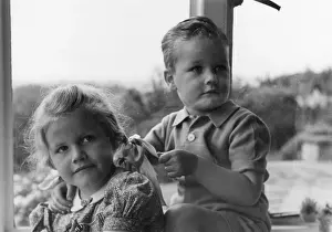 Pigtail: Boy and girl sitting in a window