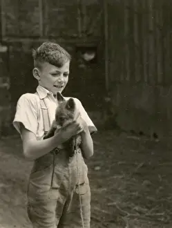 The Kathy Butler Collection: Boy holding a fox cub