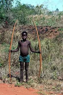 Scrapers: Boy holding palm leaf ribs used to make scapers that