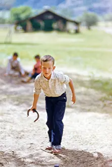 Pitching: boy - horseshoes - game - leisure activity