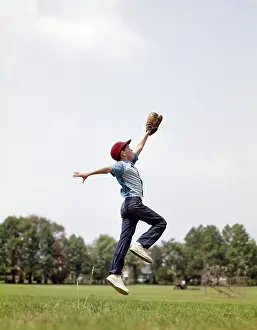 Mitt: Boy Jumping to Catch Fly Ball with Baseball Mitt