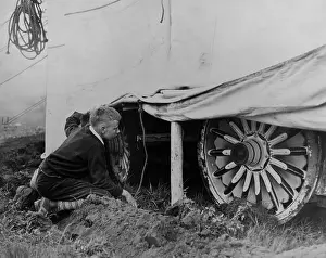Misbehavior: Boy looking under a circus tent to catches a glimpse