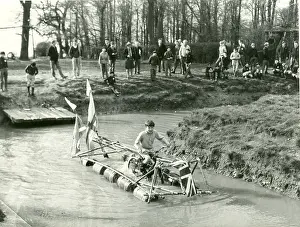 Floats: Boy operating pedal-driven drum raft