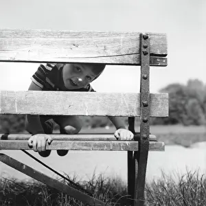 Slats: Boy peeping through a bench