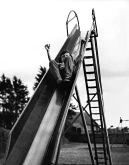 Halfway: Boy on a playground slide