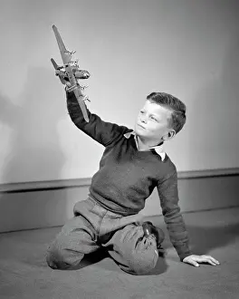 Imagining: Boy Playing with Toy Model of Four Engine Propellor