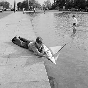 Whitestone: Boy Playing With Toy Yacht