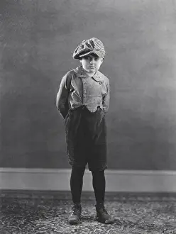 Concealing: Boy posing with hands behind back