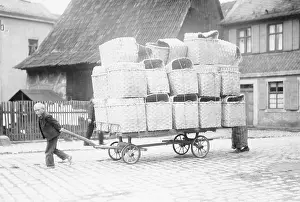 Packing: Boy pulling a ladder wagon with basketry in Upper Franconia
