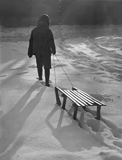 Toboggans: BOY PULLS SLEDGE C1950