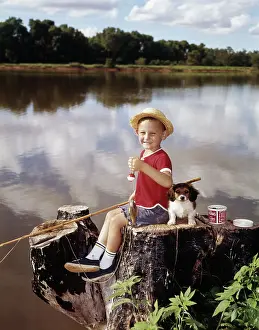 Tay001: Boy and Puppy Looking at Camera Fishing from Tree Stump