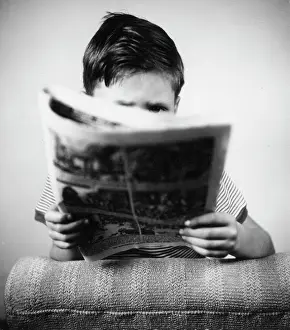 Obscures: Boy reading a comic magazine