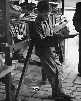 Cobblestones: Boy reading at secondhand book stall
