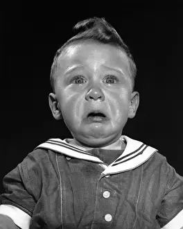 Combed: Boy in sailor suit looking up and crying