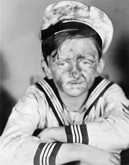 Exhausting: Boy in his sailors outfit with dirty face