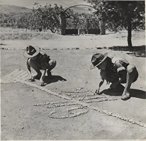 Creating: Boy scouts creating a design on the ground, Greece