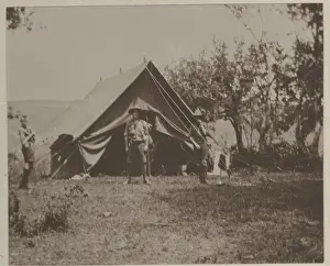 Boy scouts in front of tent at camp