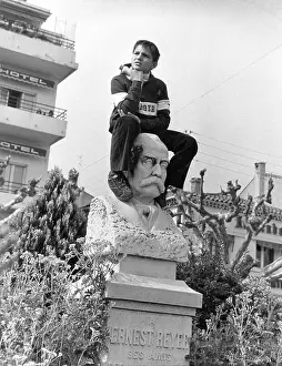 Reyer: Boy sitting on portrait bust, Le Lavandou, South of France