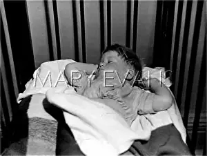 BOY SLEEPING IN COT