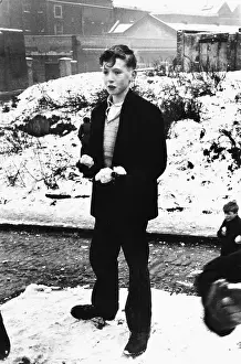 Wapping: Boy with snowballs in Wapping