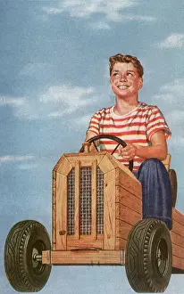 Grins: Boy in Soapbox Car