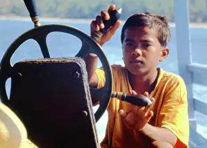 Teeshirt: Boy steering a boat, Thailand