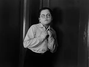 Insecure: Boy trying to listen putting his ear at a door
