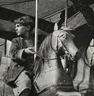 Frayed: A boy wearing frayed cloths is rideing
