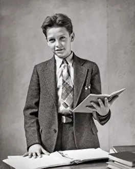 Reciting: Boy Wearing a Suit and Tie Standing Reading from