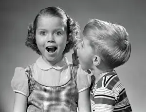 Whispers: Boy whispering in girl's ear
