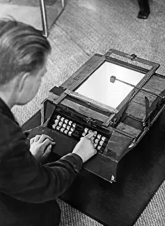 Writes: A boy writes on the first German typewriter, around the