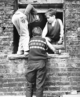 Disused: Boys at a boarded up window, Balham, SW London