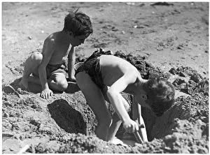 Digging: BOYS DIG IN THE SAND