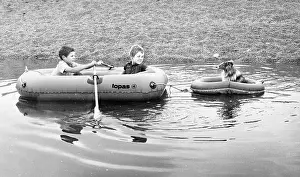 Ripples: Two boys and a dog in rubber dinghies