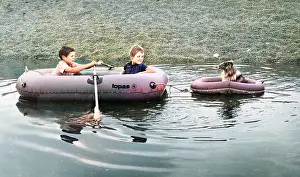 Ripples: Two boys and a dog in rubber dinghies