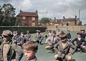 Squat: Boys exercising in school playground