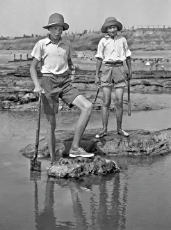 Sunhat: Two boys exploring rock pools at the seaside